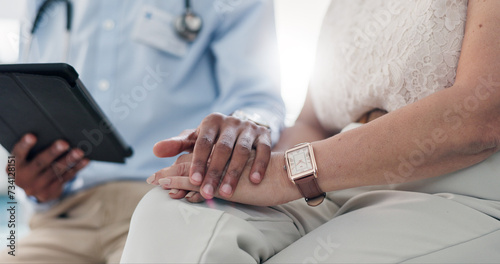 Holding hands, doctor and patient on tablet with comfort for results, cancer and empathy for kindness. People, medic or digital touchscreen with consultation, counselling or solidarity in hospital © Wesley/peopleimages.com