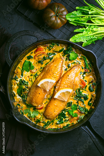Red curry with spinach, coconut milk and baked fish