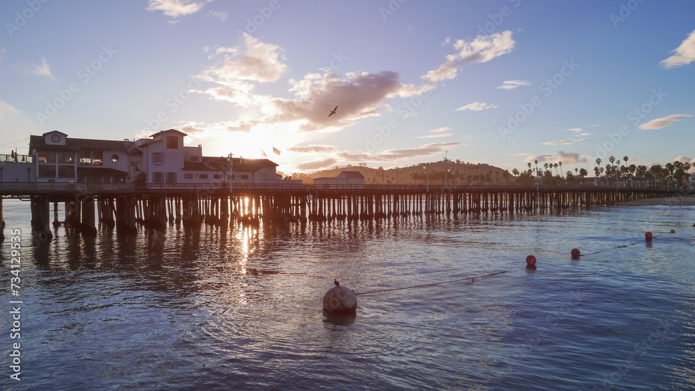 Naklejka premium Stearns Wharf on a beautiful pacific sunset after a recent rain coastline beach shore in Santa Barbara, California. Shot on a beautiful pacific sunset after a recent rain.