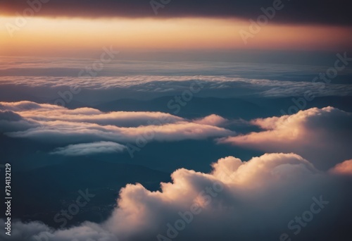The view from the airplane window to the clouds and sunset. Airplane wing above thick pink and orange clouds. Wonderful breathtaking view.