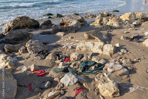 Garbage washed ashore after a storm. Pieces of cloth and plastic bags. Environmental pollution washes ashore Bat Yam Israel Winter