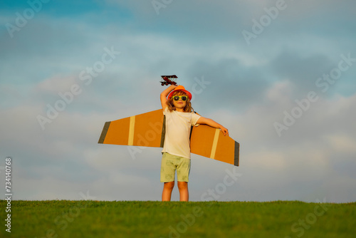 Little child boy is playing and dreaming of flying over the clouds. Child boy toddler playing with toy airplane and dreaming future. Happy boy pilot play with airplane outdoors.