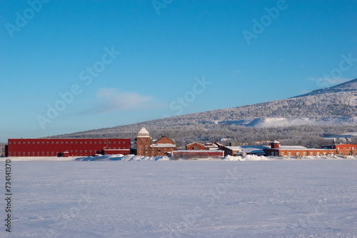 View of the mountain Loussavaara and the newly built housing next to it on a sunny winter day. Kiruna in Swedish Lapland. photo
