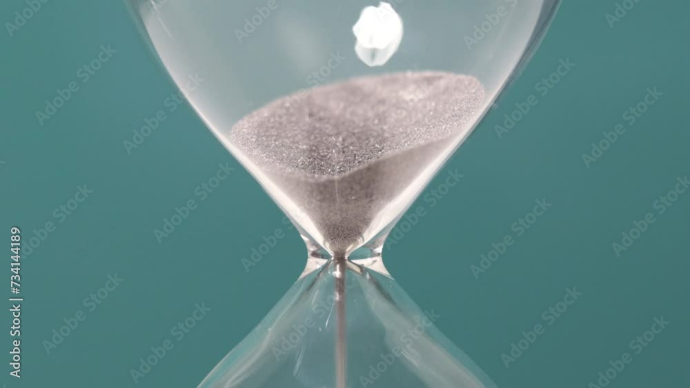 Hourglass sand detail. Concept of time passing.