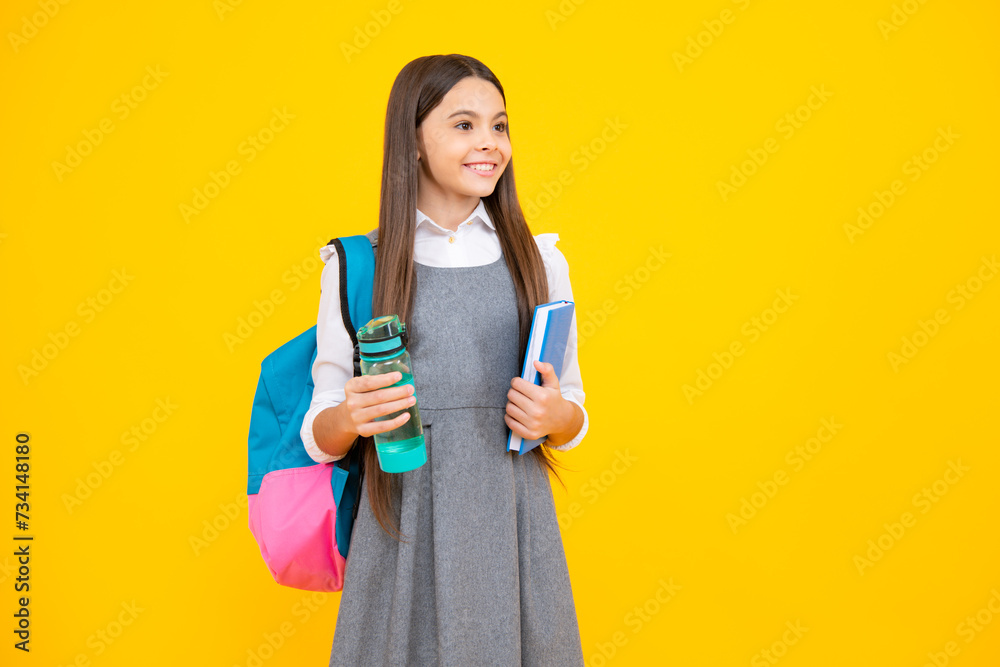 Cute school girl with backpack holding water bottle. Cute school girl with backpack holding water bottle.