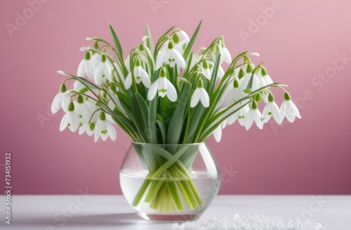 Mother's Day, Mothering Sunday, International Women's Day, bouquet of spring flowers, the onset of spring, bouquet of snowdrops in a glass vase, pink background