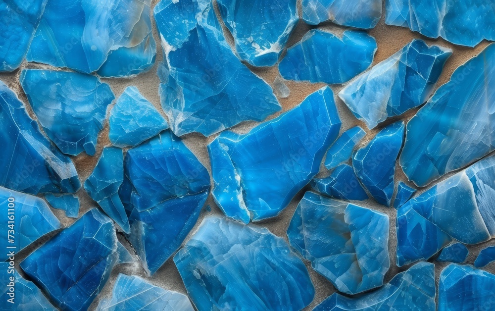 Close-up view of a wall made of irregularly shaped stones in various shades of blue. Close-up view of a wall made of irregularly shaped stones in various shades of blue.
