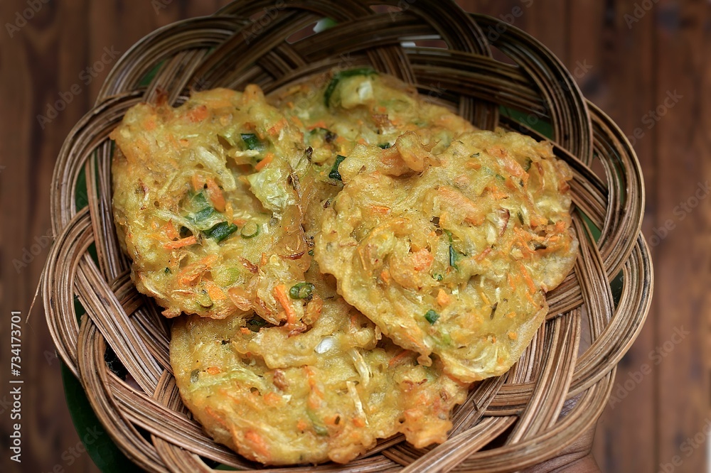 Corn Fritters with Corn. Healthy and Diet Food . Crispy fried corn ball in a white plate on wooden table, Vegetarian food, Thai food, snacks Thai style. Zucchini fritters or vegetarian zucchini pancak Corn Fritters with Corn. Healthy and Diet Food . Crispy fried corn ball in a white plate on wooden table, Vegetarian food, Thai food, snacks Thai style. Zucchini fritters or vegetarian zucchini pancak