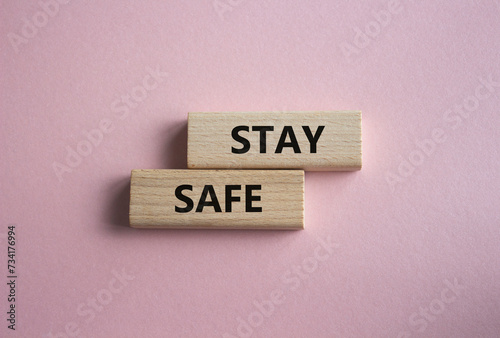 Stay Safe symbol. Concept word Stay Safe on wooden blocks. Beautiful pink background. Business and Stay Safe concept. Copy space