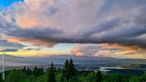 Scenic sunset view of Lake Faak seen from Altfinkenstein at Baumgartnerhoehe, Carinthia, Austria. Tranquil atmosphere on hiking trail in spring. Overlooking Villach area surrounded by Austrian Alps photo