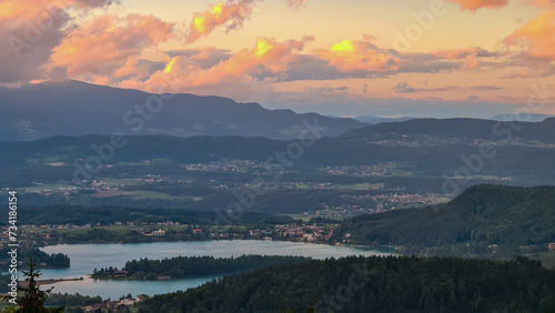 Scenic sunset view of Lake Faak seen from Altfinkenstein at Baumgartnerhoehe, Carinthia, Austria. Tranquil atmosphere on hiking trail in spring. Overlooking Villach area surrounded by Austrian Alps photo