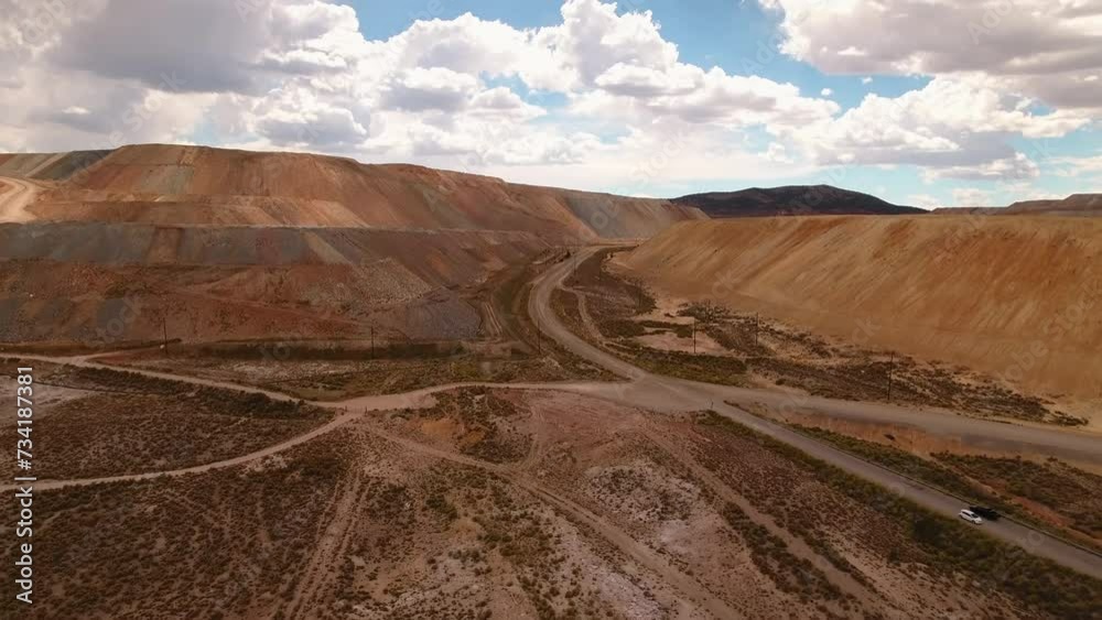 Aerial Forward Shot Of Vehicles Moving On Road In Semi Arid Desert Amidst Rock Formations Under Cloudy Sky - Ely, Nevada Aerial Forward Shot Of Vehicles Moving On Road In Semi Arid Desert Amidst Rock Formations Under Cloudy Sky - Ely, Nevada