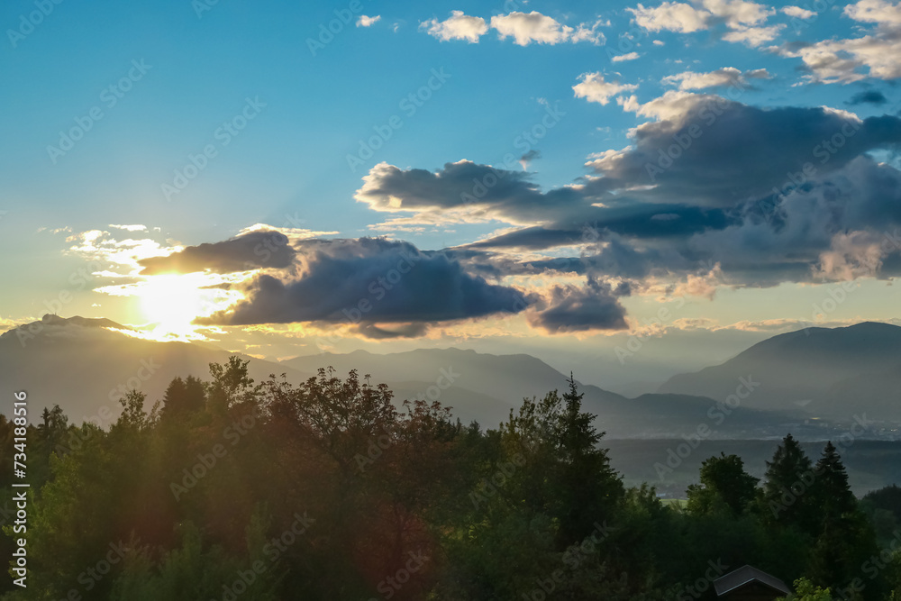 Scenic sunset view of iconic mountain peak Dobratsch seen from Altfinkenstein at Baumgartnerhoehe, Carinthia, Austria. Tranquility on hiking trail. Overlooking Villach area surrounded by Austrian Alps