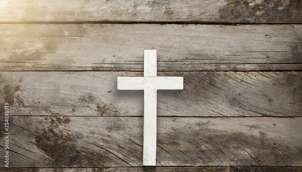 white old christian religion symbol cross shape as sign of belief on a grungy wood textured with copy space