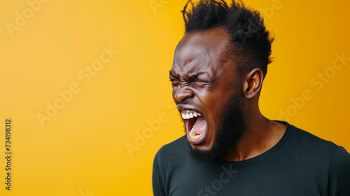 Southern African Man Reflecting Anger and Frustration, Isolated on Solid Background - Copy Space Provided photo