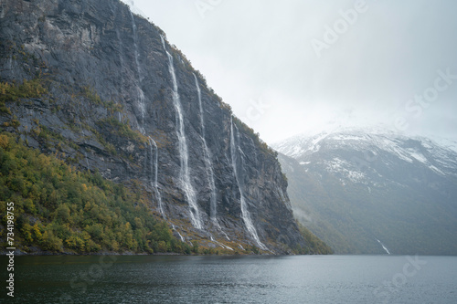 Panoramic image of the fjords of Norway in autumn  at sunset  with the Geiranger waterfalls.