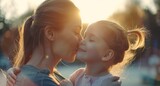 Mother and daughter bonding. Loving family connection, parent-child closeness. Cute little preschooler daughter hug cuddle with smiling young mother kiss.