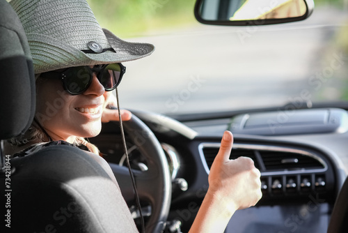 A driver driving in hat  a car on the road © Kostia
