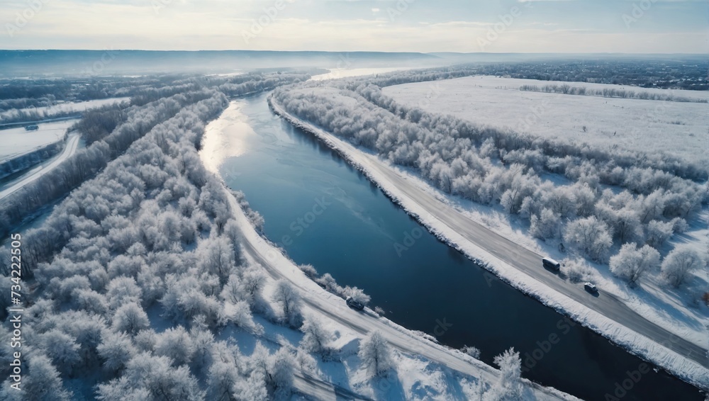 Aerial top view of snow winter road with cars over blue river Aerial top view of snow winter road with cars over blue river