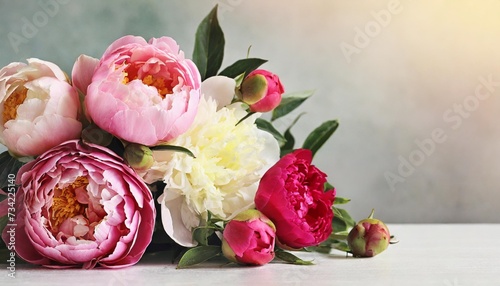 beautiful peony flowers and roses on a light background flower arrangement with place for text summer banner greeting card for wedding birthday template for design selective focus