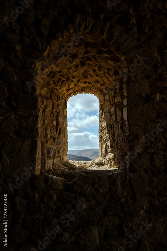 close up detail of crusader castle with dry desert heat. Rocks and mortar from sand stone. Dark tunnels and deep contrast. Graphic design resource no people. Historic building techniques. Castle ruins