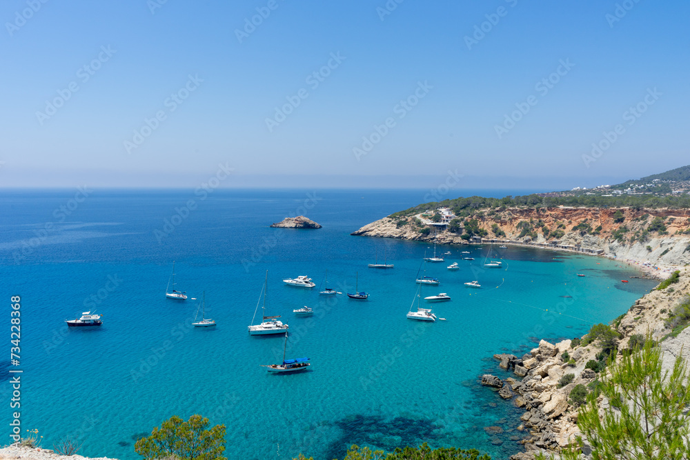 Perfect Mediterranean bay on the island of Ibiza with lots of boats and yachts moored.Tourist destination. Holiday. Vacation.