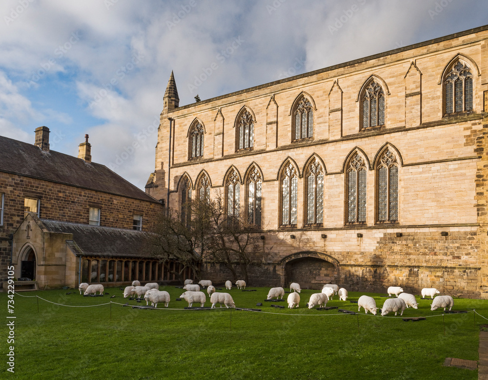 Fototapeta premium Hexham Abbey, Northumberland, UK with sheep display.