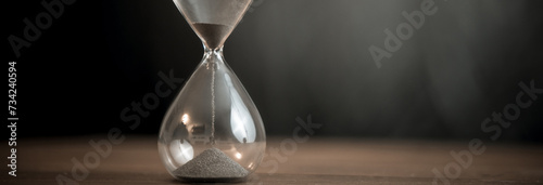Hourglass on wooden background