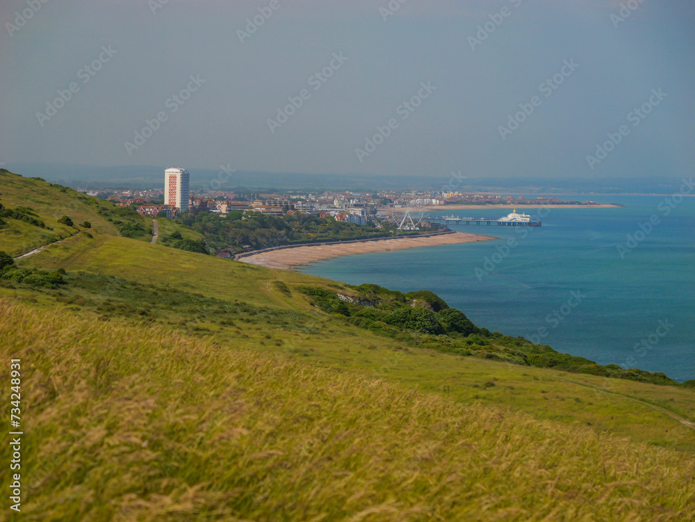 Picturesque coastline view from a grassy cliff with coastal town of Eastbourne Picturesque coastline view from a grassy cliff with coastal town of Eastbourne