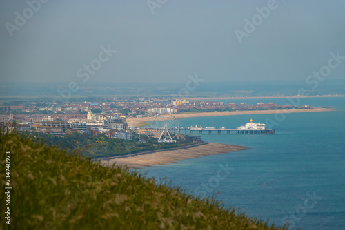 View from the cliff over green grass to the beautiful seaside town of Eastbourne