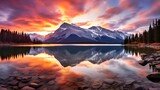 a breathtaking sunset over a pristine mountain range, casting vibrant hues across the sky and reflecting on a crystal-clear lake.