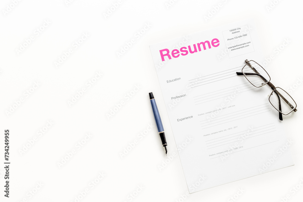 Top view of resume files on HR manager table. Reviewing resume applications. Searching for new employees Top view of resume files on HR manager table. Reviewing resume applications. Searching for new employees