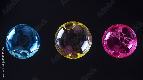  a group of three different colored objects on a black background with a black background and a black background with a red  yellow  blue  and pink  and green colored object.