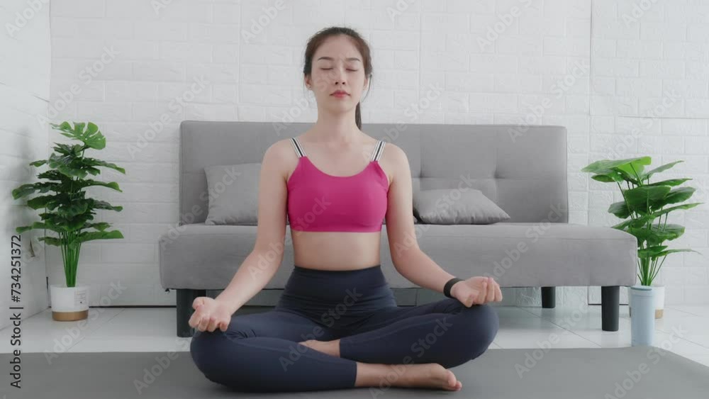 Young sporty attractive woman practicing yoga in living room, working out, wearing sportswear, Young sporty attractive woman practicing yoga in living room, working out, wearing sportswear,