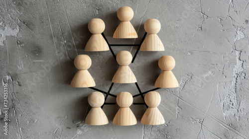 network or hierarchy concept with wooden figures connected by black lines on a dark, textured background.