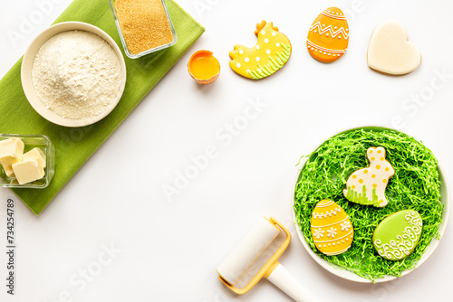 Easter eggs and bunny cookies with ingredients. Baking cooking flat lay