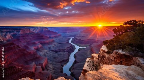 a panoramic view of a canyon at sunset, with the rugged terrain bathed in warm hues and the sky ablaze with the last light of the day.