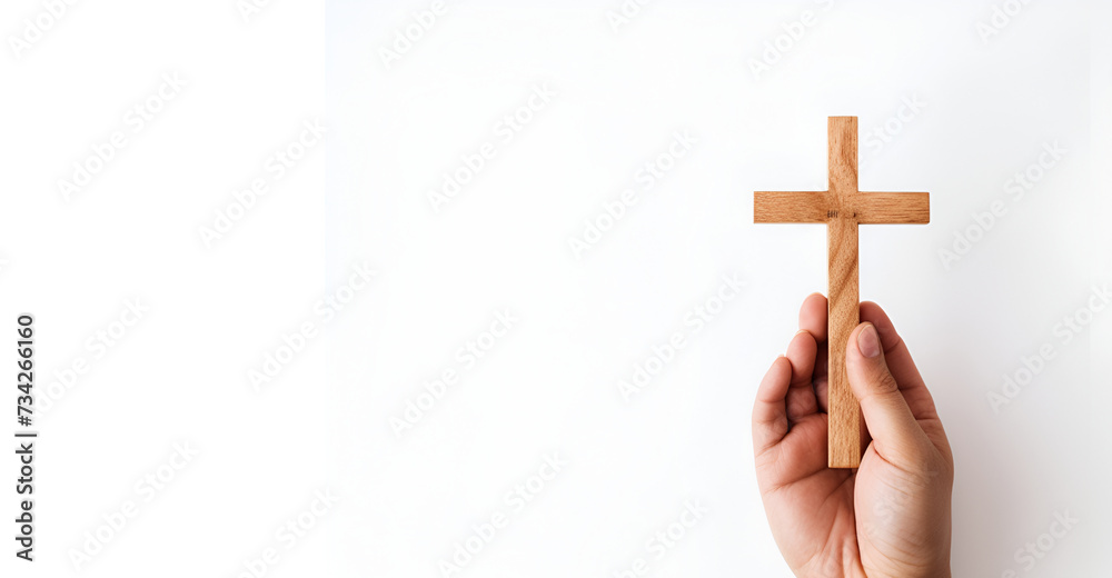 hand holding wooden cross on white background generated AI