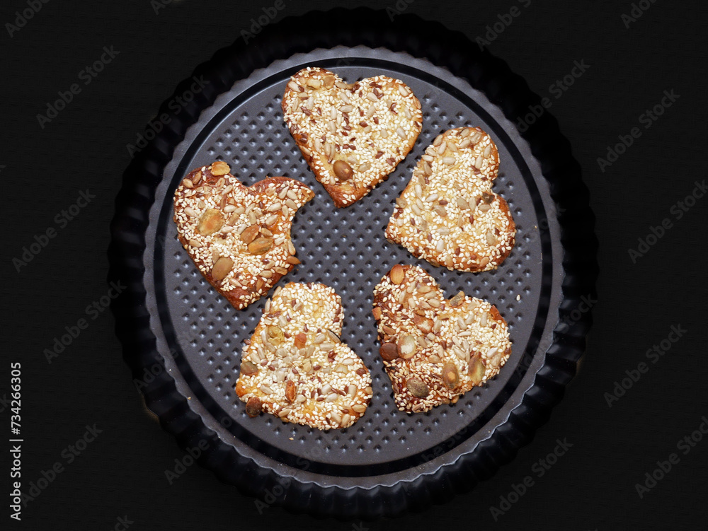 Delicious shortbread biscuits with pumpkin seeds, sunflower seeds, sesame seeds and linseeds. A healthy heart-shaped snack.