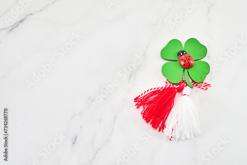 First of march celebration Martisor, Baba marta. Red and white rope and lalybug. photo