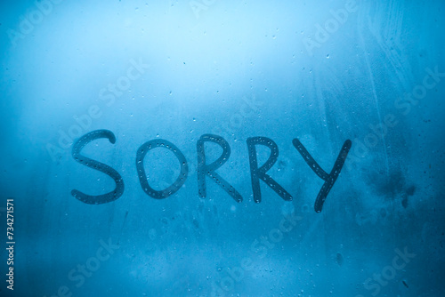 The inscription "sorry" on the window glass