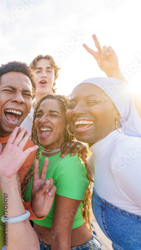 Crazy group of multi-ethnic friends taking a happy selfie