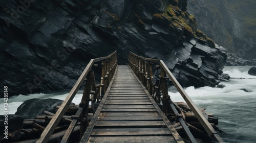 a wooden bridge over a body of water next to a rocky cliff with water rushing down the side of it.