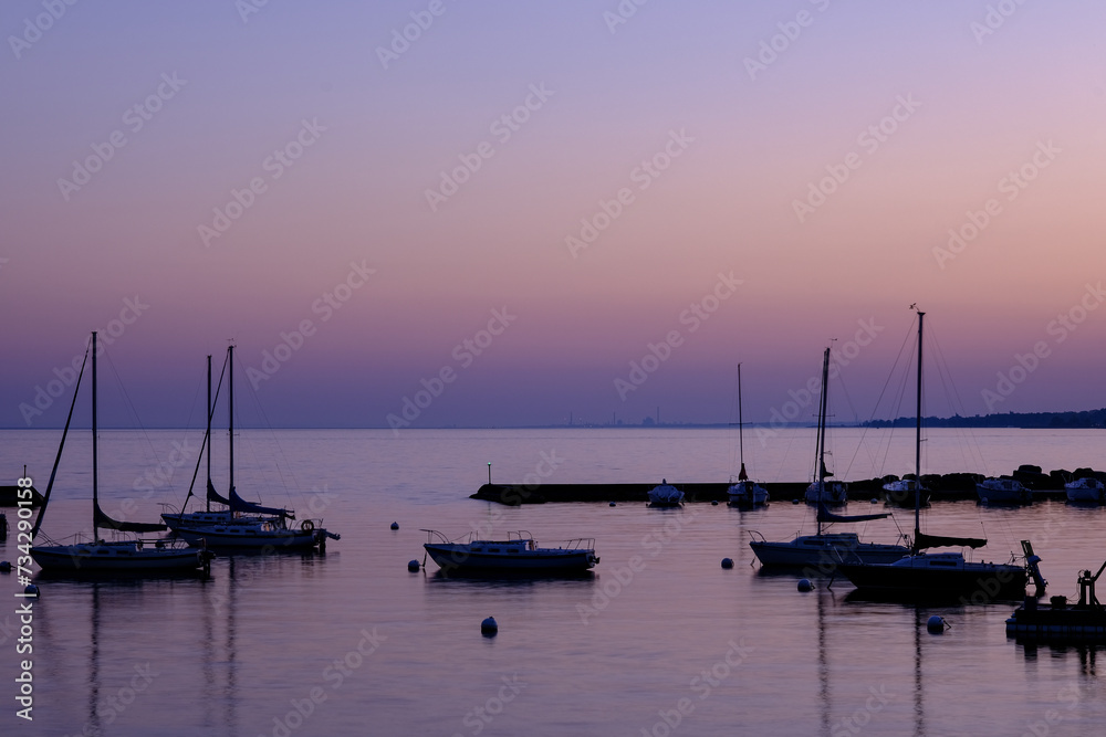 Boats at dusk in Toronto park with lake view and boats