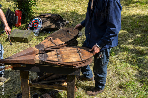 Blacksmith with the ancient bellows blowing the coals for forging during the folk festival 