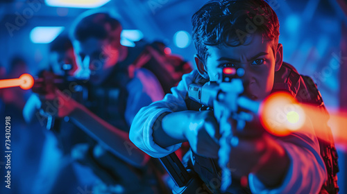 Intense laser tag match with focused boys aiming guns © Sunshine Design