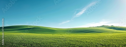 Rolling green hills under a vast blue sky with a gentle breeze visible in the sway of the grass.