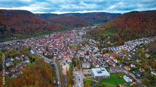 Aerial around the city Bad Urach in Germany on a sunny day in Autumn