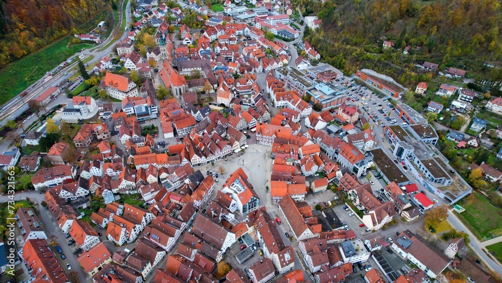 Aerial around the city Bad Urach in Germany on a sunny day in Autumn