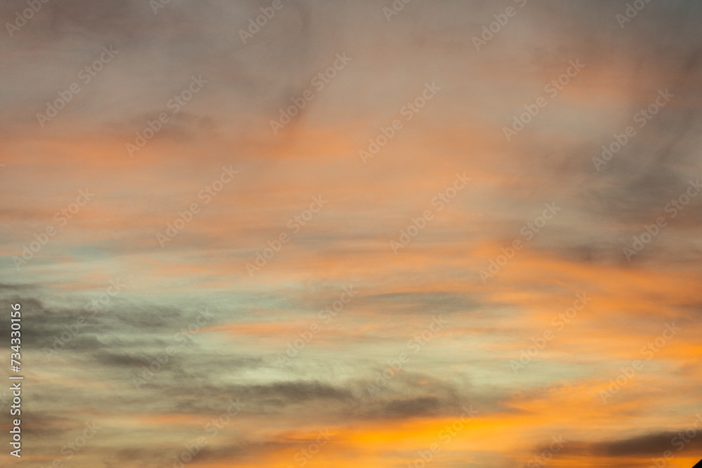 Golden, orange and blue clouds at sunset